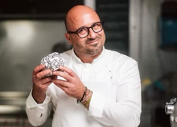 Laurent Eperon — 2-Michelin-starred chef holding a SmashClub burger